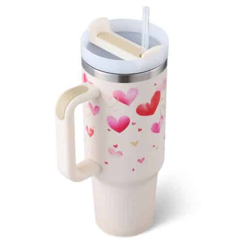 Insulated tumbler with hearts design and straw.