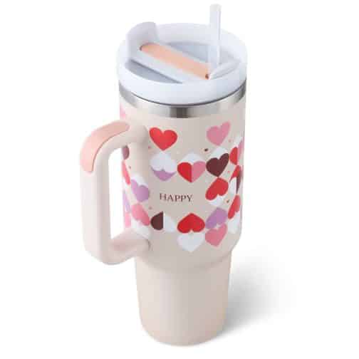 Insulated travel mug with colorful heart design and straw.