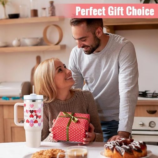 Couple exchanging gifts, festive atmosphere, cozy kitchen setting.