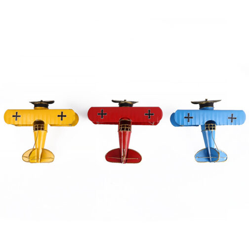 Three colorful vintage model airplanes on white background.