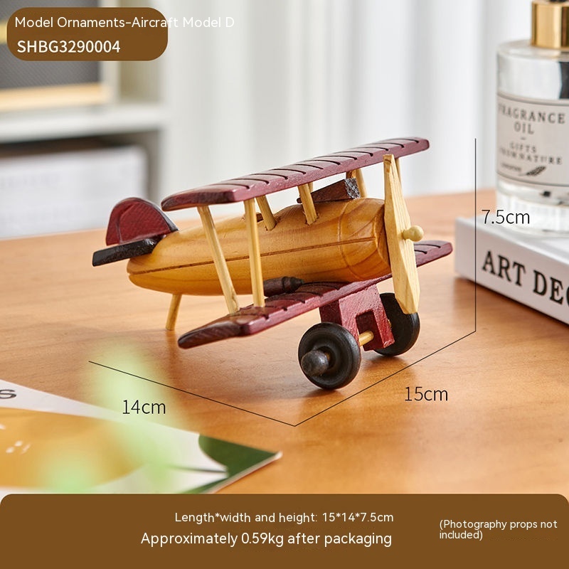 Wooden model airplane on table with measurements.