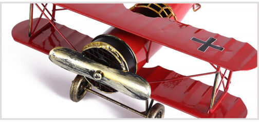 Red biplane model with cross symbol on wings.