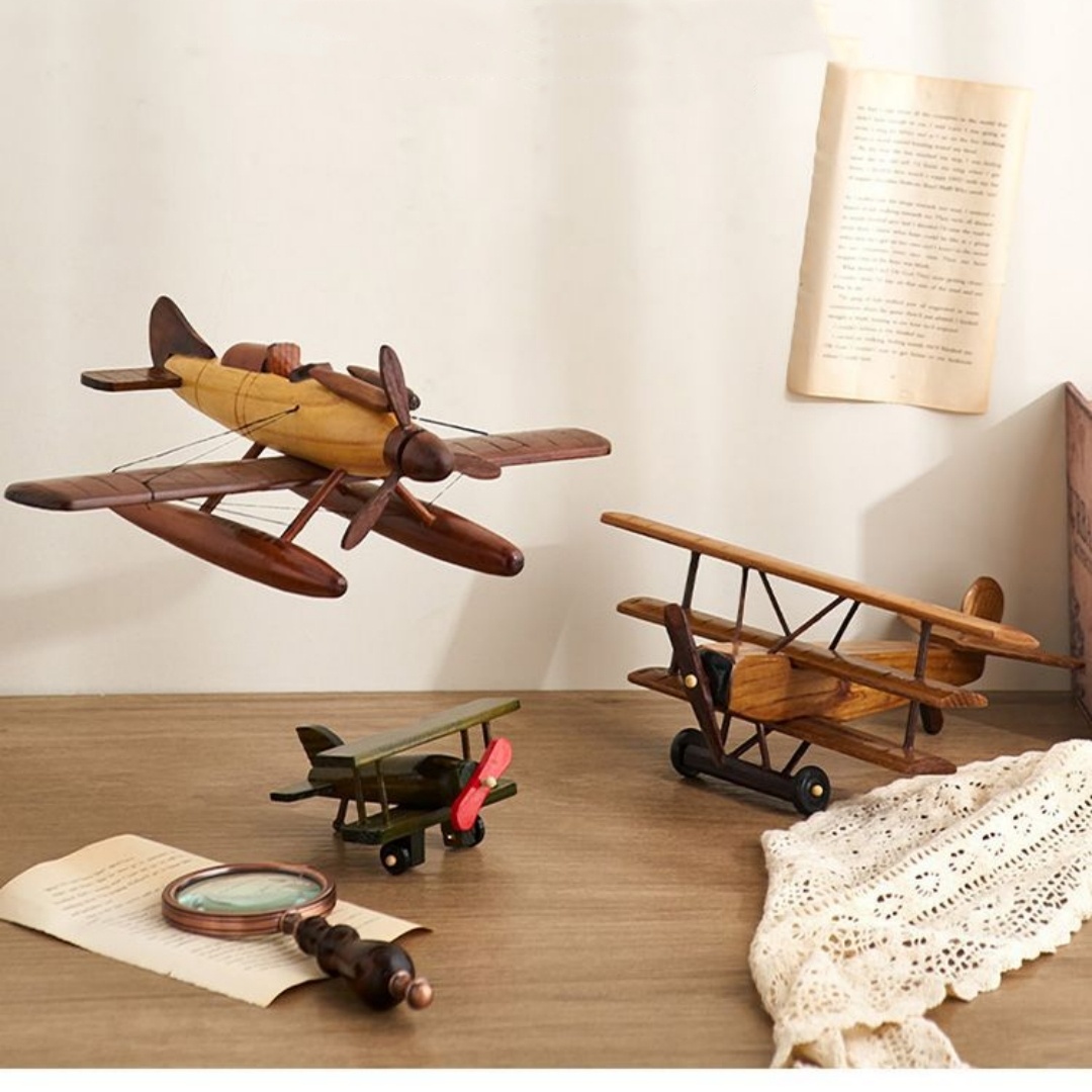 Vintage model airplanes and magnifying glass on desk.