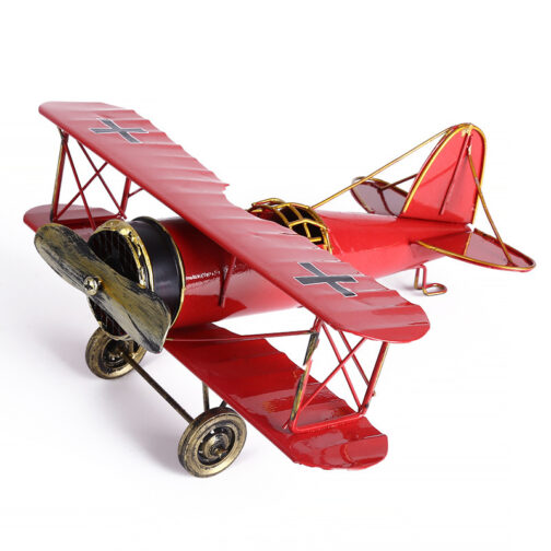Red vintage biplane model with cross symbols