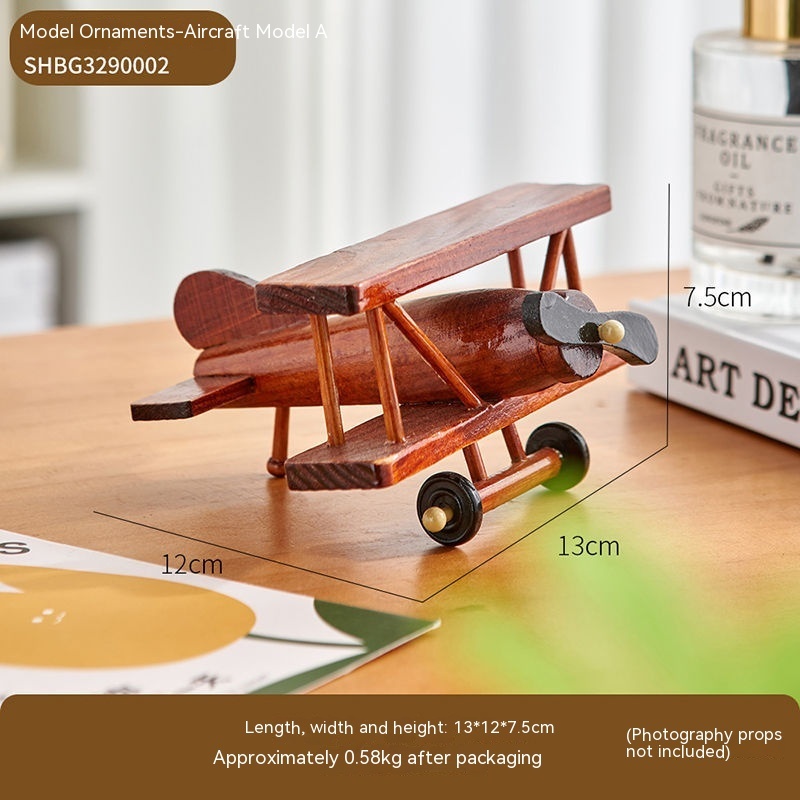Wooden model airplane on tabletop, dimensions included.