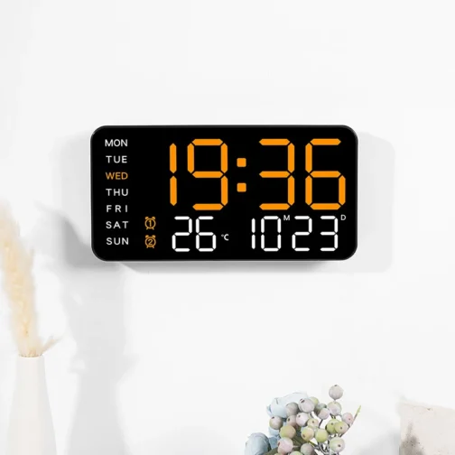 Digital wall clock displaying time, temperature, and date.