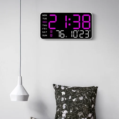 Digital clock on a wall showing time and date.