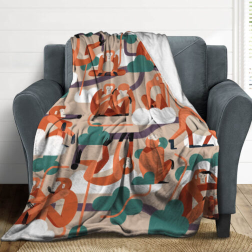 Colorful monkey-patterned blanket draped over a chair.