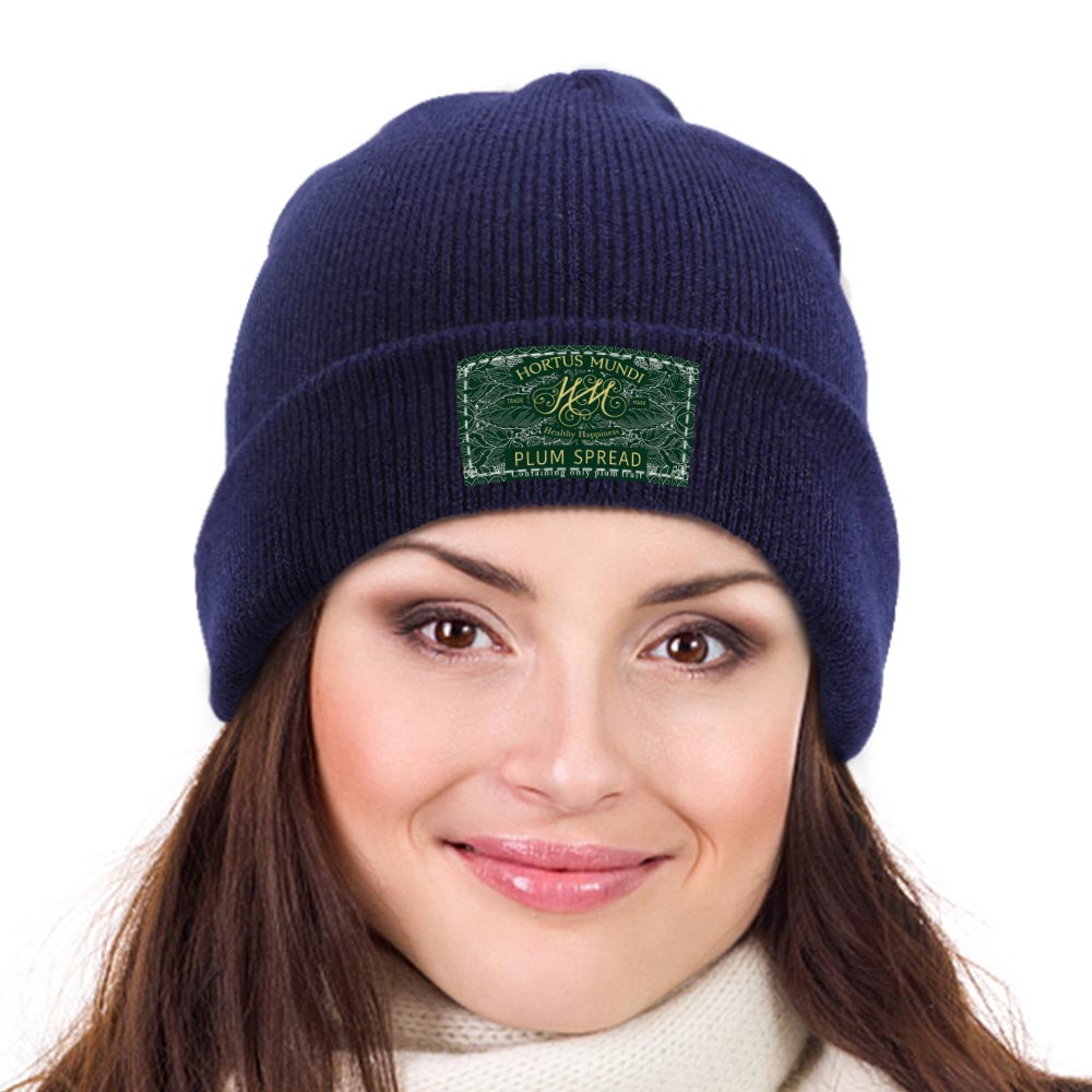 Woman wearing navy beanie with label design.