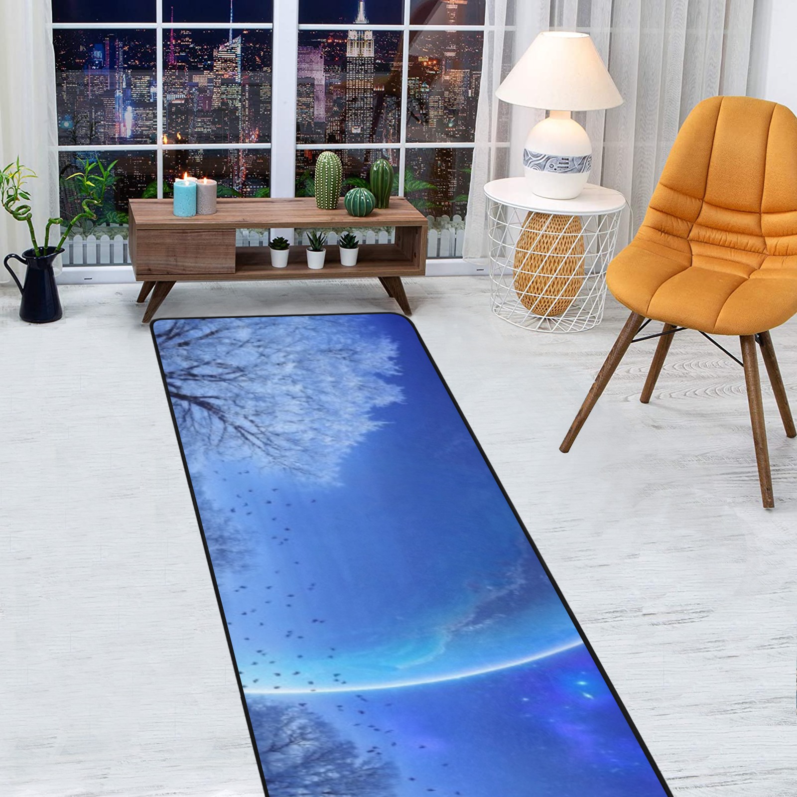 Modern living room with window view and blue rug.