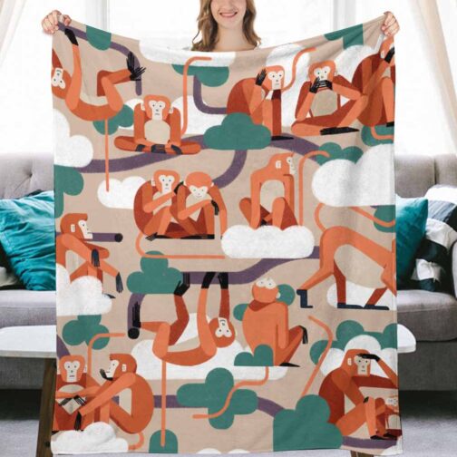 Blanket with playful monkey pattern on couch.