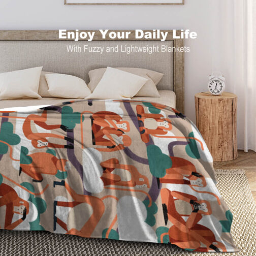 Colorful monkey blanket on bed with pillows.